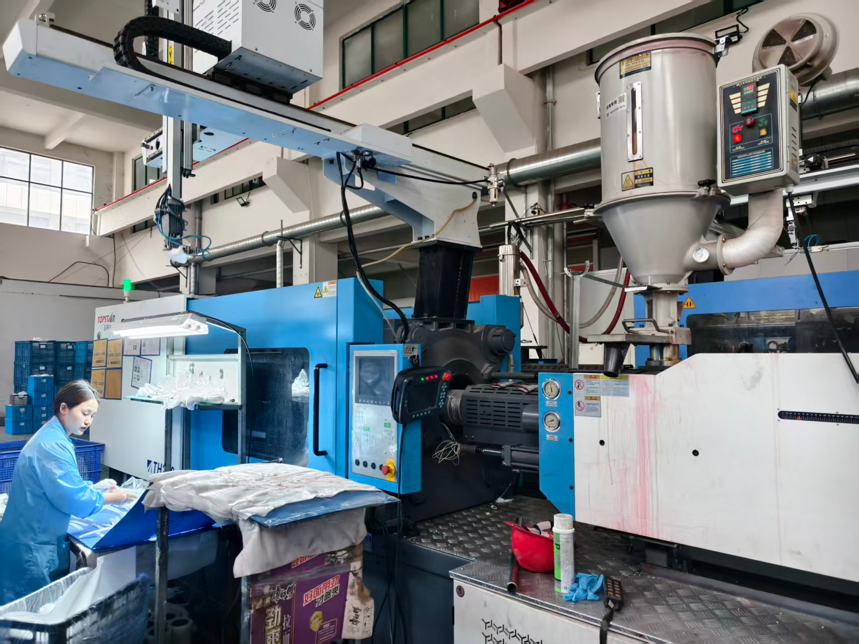 Operator monitoring injection molding equipment at the Feng Cheng facility